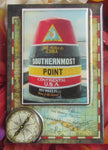 Magnet picture showing a 3D design of the Southernmost Point set on an old map and compass.