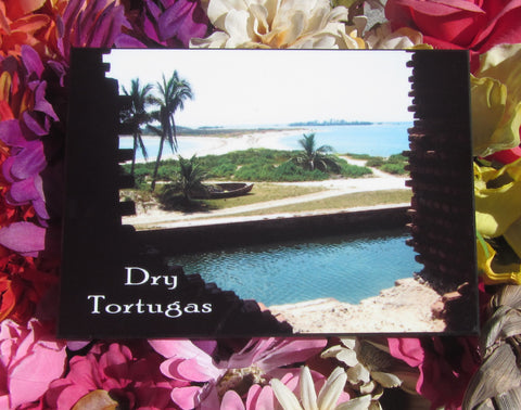 Photo Panel 5" x 7" showing a picture taken from inside Fort Jefferson on the island of The Dry Tortugas. The bricks of the fort frame the view of the surrending water way, the stretch of land where sits a row boat and the limitless ocean.