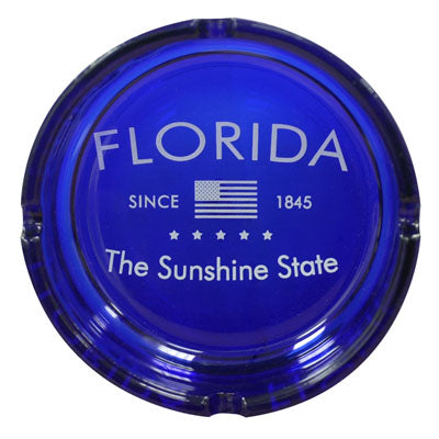 Ashtray picture showing "FLORIDA" on top, the American flag and "SINCE 1845" in the middle, "The Sunshine State" at the bottom, with a royal blue background.
