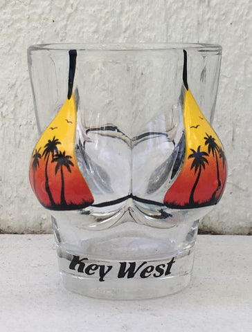 Shot glass shaped like a woman bust wearing a "palm tree sunset" design bikini top  with "Key West".