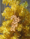 Wood ornament in the shape of a kitty holding on to a sugarcane as big as itself. With "Key West".