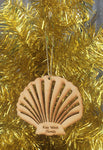 Wood ornament in the shape of a scallop shell. With "Key West Florida".