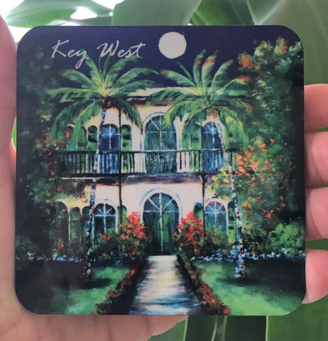 Hardboard Coaster picture showing a painting of the Hemingway House with "Key West" (white letters).