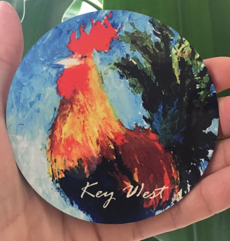 Hardboard Coaster round showing a painting of a colorful rooster with "Key West" (white letters).