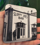 Hardboard Coaster showing a mid 20th century picture of Sloppy Joe's Bar and the mug handle.