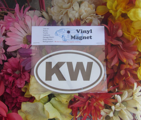 Oval KW auto magnet pictured in its wrapper. This magnet is oval with "KW" (black capital letters) and white background.