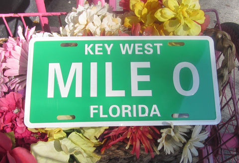 License Plate picture showing the Mile 0 design with "MILE 0" (big white letters in the middle, "KEY WEST" (smaller white capital letters) and "FLORIDA" (smaller white capital letters), in a light green background.