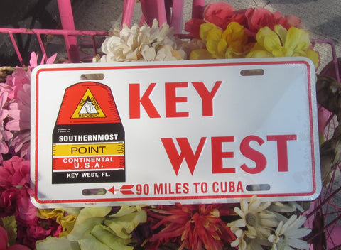 License Plate picture with the Southernmost Point (on the left) and big capital red letters 'KEY WEST" (center and right), "90 MILES TO CUBA (smaller red capital letters) at the bottom, with a white background.