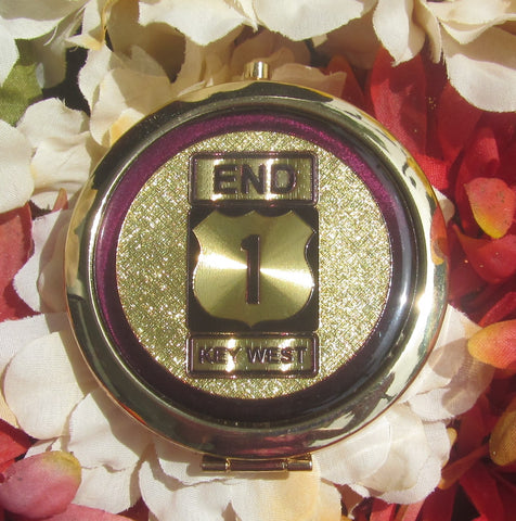 Compact Mirror picture showing a golden design of the US 1 sign "End" and "Key West".