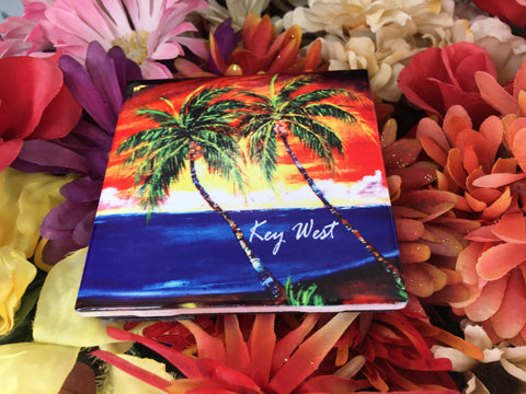 Ceramic Tile 4.25" x 4.25" picture showing a painting of palm trees in front of a sunset waterview.