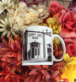 Side view mug showing a mid 20th century picture of Sloppy Joe's Bar and the mug handle.