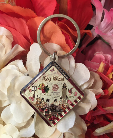 Key Chain showing a diamond shape vintage look design showing the Southernmost Point, the US 1 sign, the Lighthouse, Sloppy Joes, the trolley and a schooner  with "Key West".