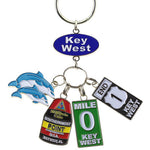 Key Chain with a "Key West" on an oval blue backgroup and 4 charms hanging underneath: a couple of dolphins, the Southernmost Point, Mile 0 sign and End US 1 sign.