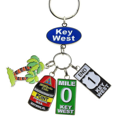 Key Chain with a "Key West" on an oval blue backgroup and 4 charms hanging underneath: a palm tree, the Southernmost Point, Mile 0 sign and End US 1 sign.
