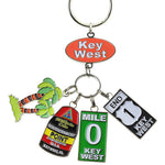 Key Chain with a "Key West" on an oval orange backgroup and 4 charms hanging underneath: a palm tree, the Southernmost Point, Mile 0 sign and End US 1 sign.