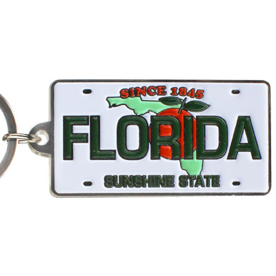 Key Chain showing a Florida license plate design with the map of Florida covered by an orange with leaf, "SINCE 1845" on top, "FLORIDA" in the middle and "SUNSHINE STATE" at the bottom.