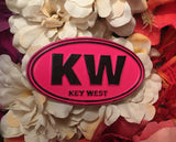 Magnet in oval shape with "KW" and "Key West". Pink and black.