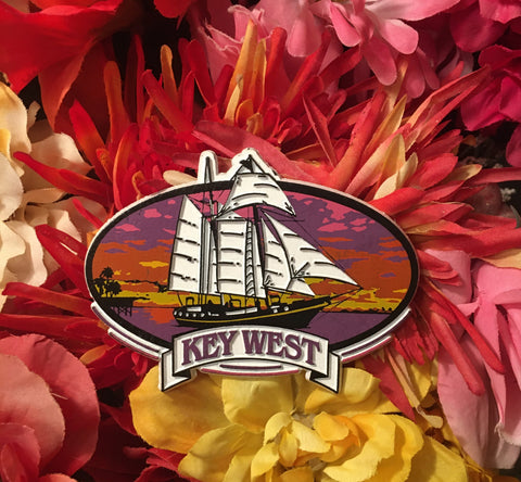 Magnet showing a schooner sailing at sunset. With "Key West".