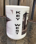 Front view mug showing "KEY WEST" written vertically between the Flagler's train and Sloppy Joe pictures.