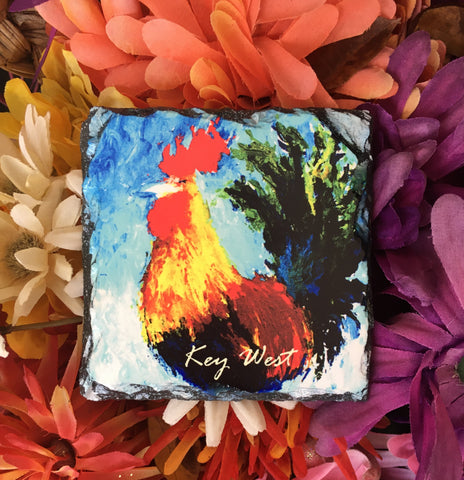 Slate Coaster showing a painting of a colorful rooster with "Key West" (white letters).