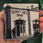 Rubber Coaster showing a mid 20th century picture of Sloppy Joe's Bar and the mug handle.