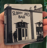 Rubber Coaster showing a mid 20th century picture of Sloppy Joe's Bar and the mug handle.