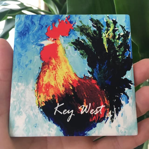 Sandstone Coaster showing a painting of a colorful rooster with "Key West" (white letters).