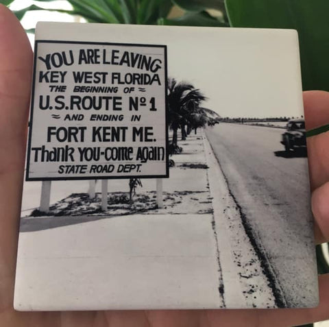 Sandstone Coaster showing a mid 20th century picture of a Sate Road sign located on US1: "YOU ARE LEAVING KEY WEST FLORIDA, THE BEGINNING OF U.S. ROUTE No. 1 AND ENDING IN FORT KENT ME.", "Thank you - Come again - Sate Road Dept."