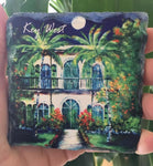Slate Coaster picture showing a painting of the Hemingway House with "Key West" (white letters).