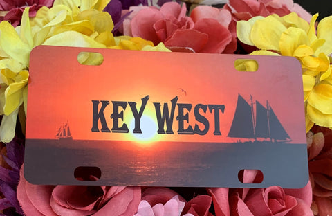 Mini License Plate showing a sunset on the water with two sailboats going in opposite directions with "KEY WEST".