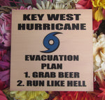 Wood Panel 8" x 8" showing the blue hurricane logo and "KEY WEST HURRICANE EVACUATION PLAN", "1. GRAB BEER", "2. RUN LIKE HELL" (white background)