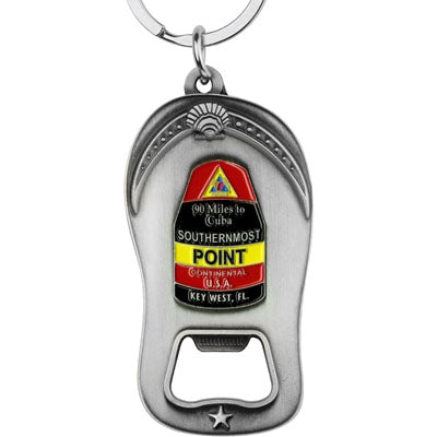 Pewter style bottle opener key chain showing the Southernmost Point:  at the top, a triangular design showing a conch shell (red background), then underneath "90 Miles to Cuba" and "SOUTHERNMOST" with a black background, then underneath "POINT" with a yellow background, then underneath "CONTINENTAL U.S.A." with a red background and finally at the bottom "KEY WEST, FL" with a black background.