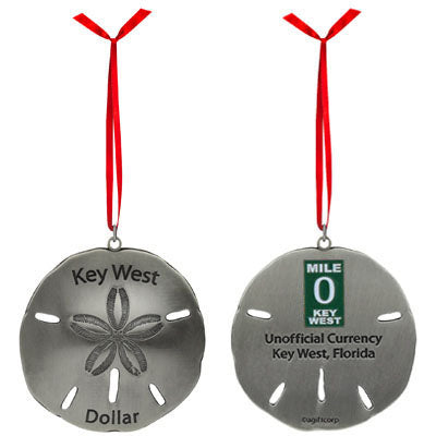 Metal ornament in the shape of a sandollar with "Key West Dollar" on the front. On the back: the Mile 0 sign and "Unofficial Currency", "Key West, Florida". The picture shows that item in silver.