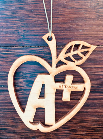 Wood ornament in the shape of an apple centered by a A+ and "#1 Teacher".