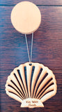 Wood ornament in the shape of a scallop shell. With "Key West Florida".