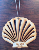 Wood ornament in the shape of a scallop shell. With "Key West Florida".