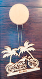 Wood ornament in the shape of a motorcycle in front of two palm trees. With "Key West".