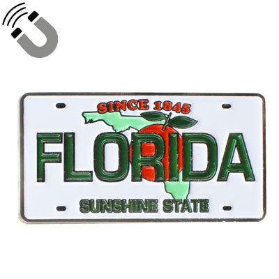 Magnet showing a Florida license plate design with the map of Florida covered by an orange with leaf, "SINCE 1845" on top, "FLORIDA" in the middle and "SUNSHINE STATE" at the bottom.