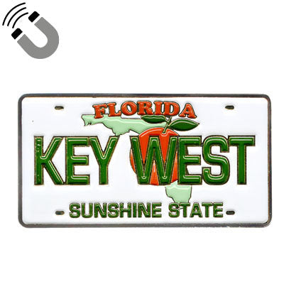 Magnet showing a Florida license plate design with the map of Florida covered by an orange with leaf, "FLORIDA" on top, "KEY WEST" in the middle and "SUNSHINE STATE" at the bottom.