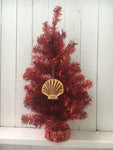 Wood ornament in the shape of a scallop shell. With "Key West Florida".