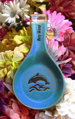 Blue color spoon rest showing a jumping dolphin, with "Key West" on the handle.
