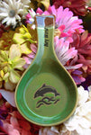 Green color spoon rest showing a jumping dolphin, with "Key West" on the handle.