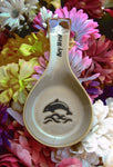 Natural color spoon rest showing a jumping dolphin, with "Key West" on the handle.