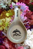 Natural color spoon rest showing a jumping dolphin, with "Key West" on the handle.