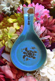 Blue color spoon rest showing a sea turtle, a tiny fish and a seashell, with "Key West" on the handle.