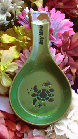 Green color spoon rest showing a sea turtle, a tiny fish and a seashell, with "Key West" on the handle.
